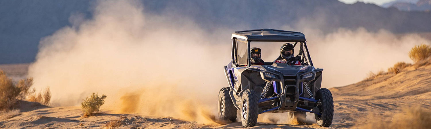 Two riders in a 2020 Honda® Talon 1000X race across the dunes